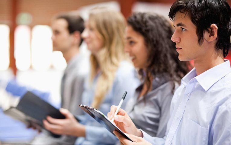 Business people taking notes during a presentation